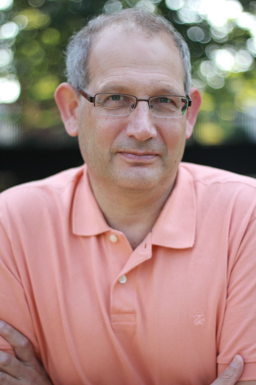Tom Michelman - headshot of man in peach shirt